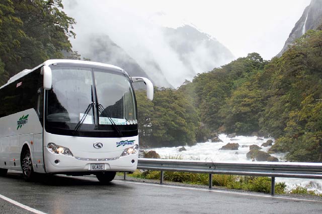Tracknet bus making it's way alongside the Hollyford River