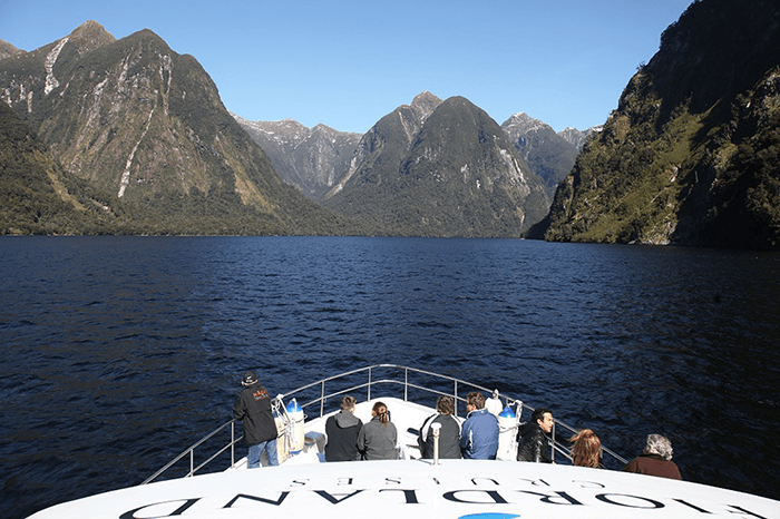 View looking towards the bow of Fiordland Cruises vessel, the Southern Secretwith people enjoying the views
