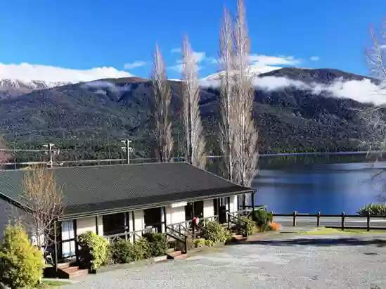 View from Te Anau Lakeview Holiday Park unit over Lake Te Anau on a calm day