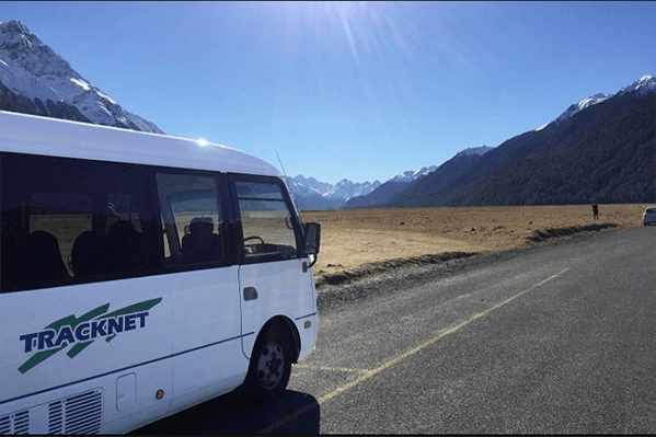 Tracknet bus with the Eglinton Valley in the background